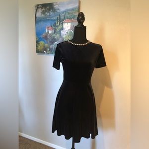 Adorable black, velvet feel embellished scoop neck.